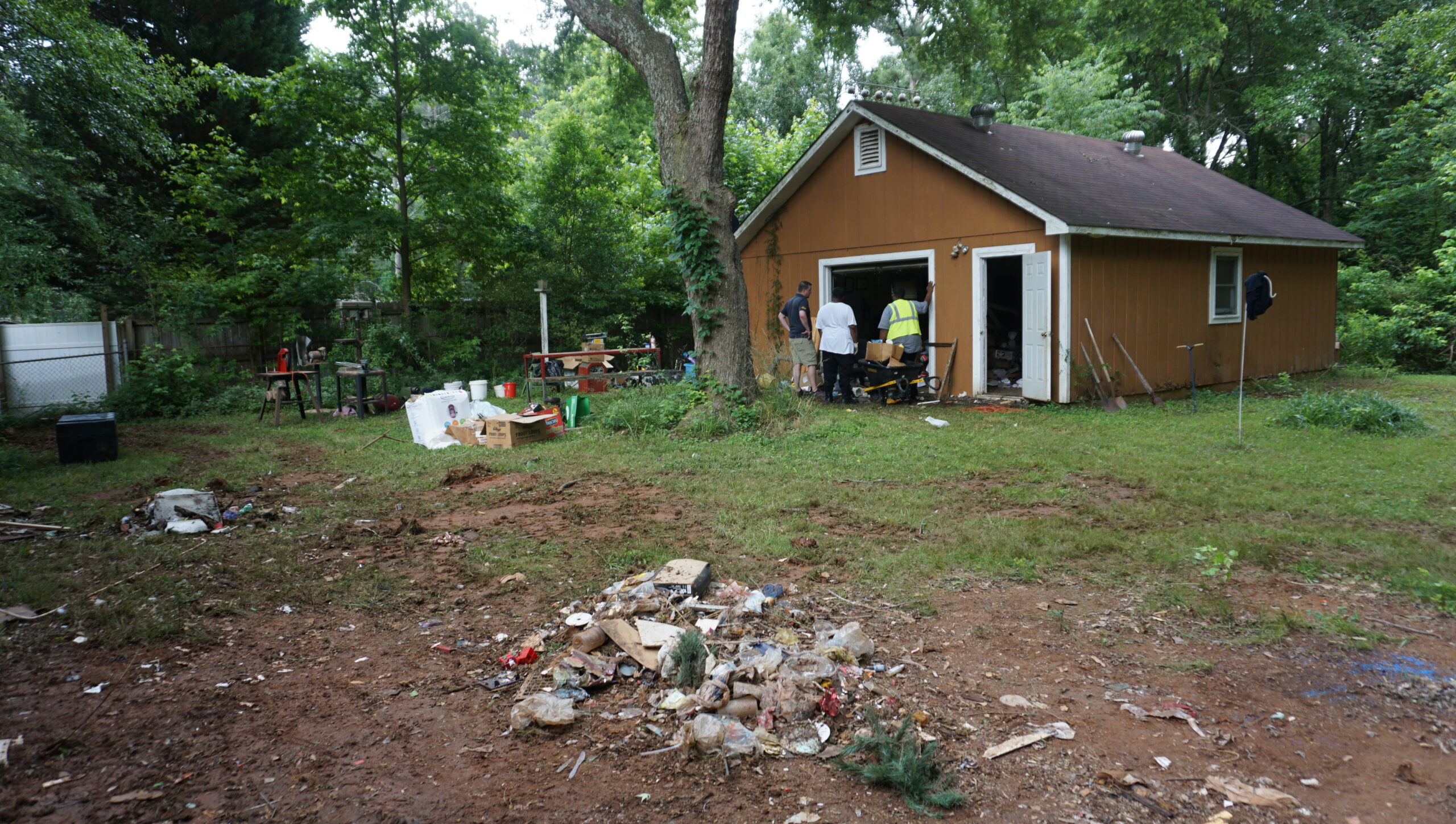 Residential property backyard before full gut renovation Atlanta GA — debris, deteriorated outbuilding