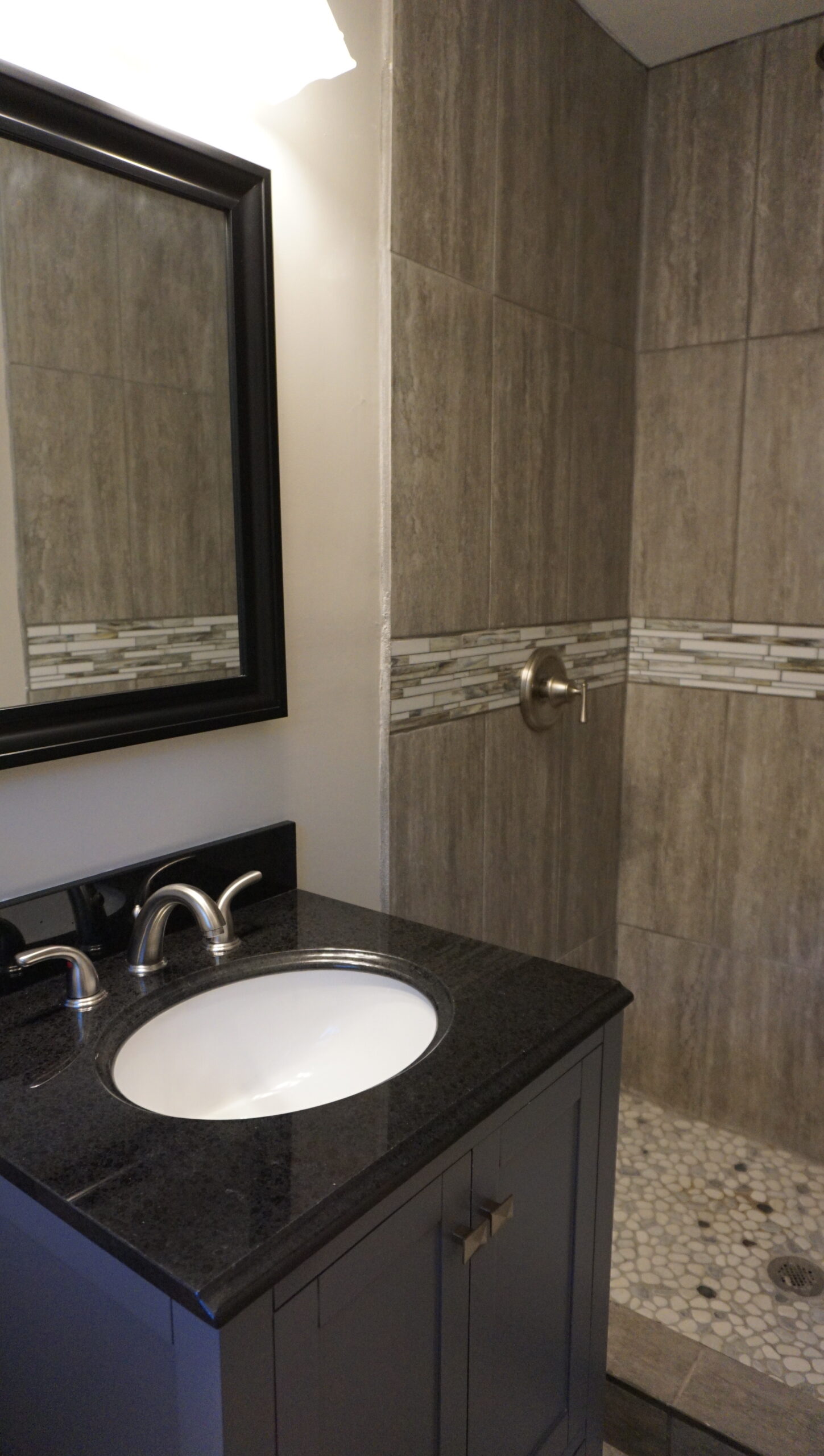 Master bathroom renovation Atlanta GA — walk-in tile shower, black granite vanity, brushed nickel fixtures
